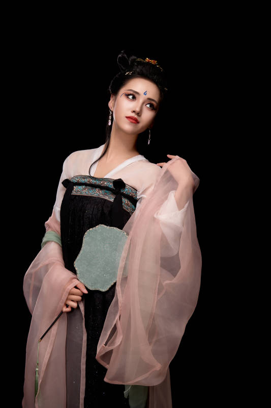 手持轻扇展示唐代服饰妆容造型的东方女性图片