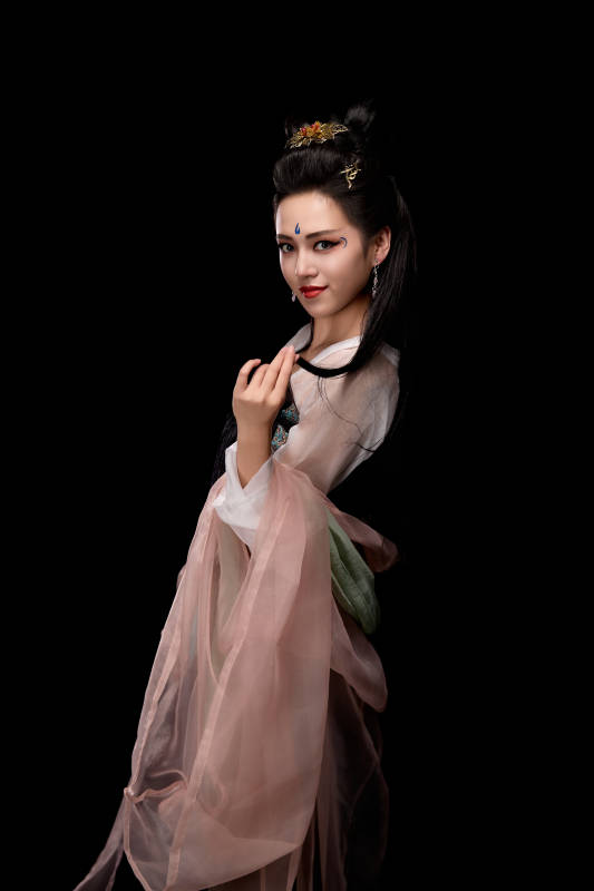 手持轻扇展示唐代服饰妆容造型的东方女性图片