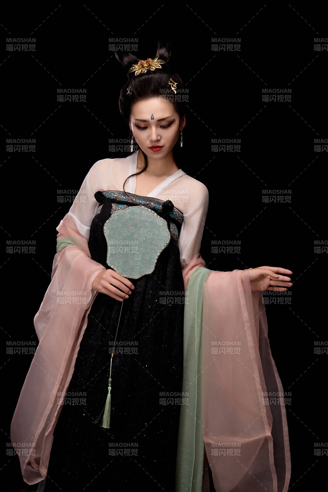 手持轻扇展示唐代服饰妆容造型的东方女性图片