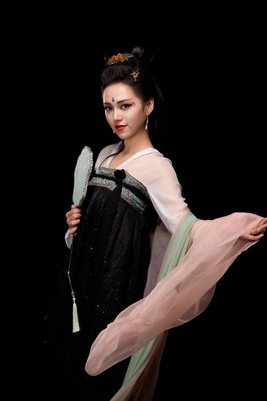手持轻扇展示唐代服饰妆容造型的东方女性图片