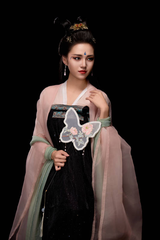 手持蝶扇展示唐代服饰妆容造型的东方女性图片