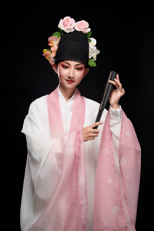 身着粤剧戏曲反串装扮手持折扇的青年女性图片