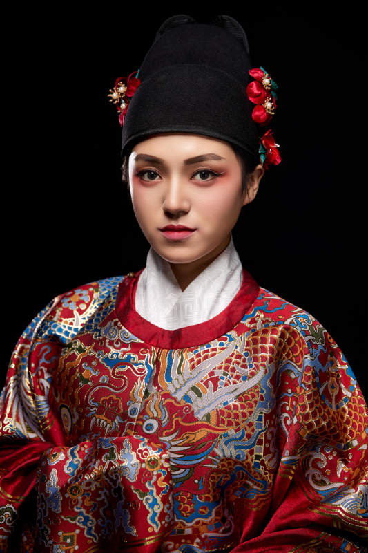 黑色背景下身着明代飞鱼服的青年女性图片