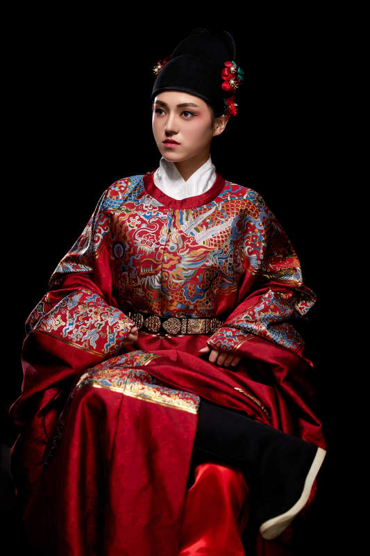 黑色背景下身着明代飞鱼服的青年女性图片