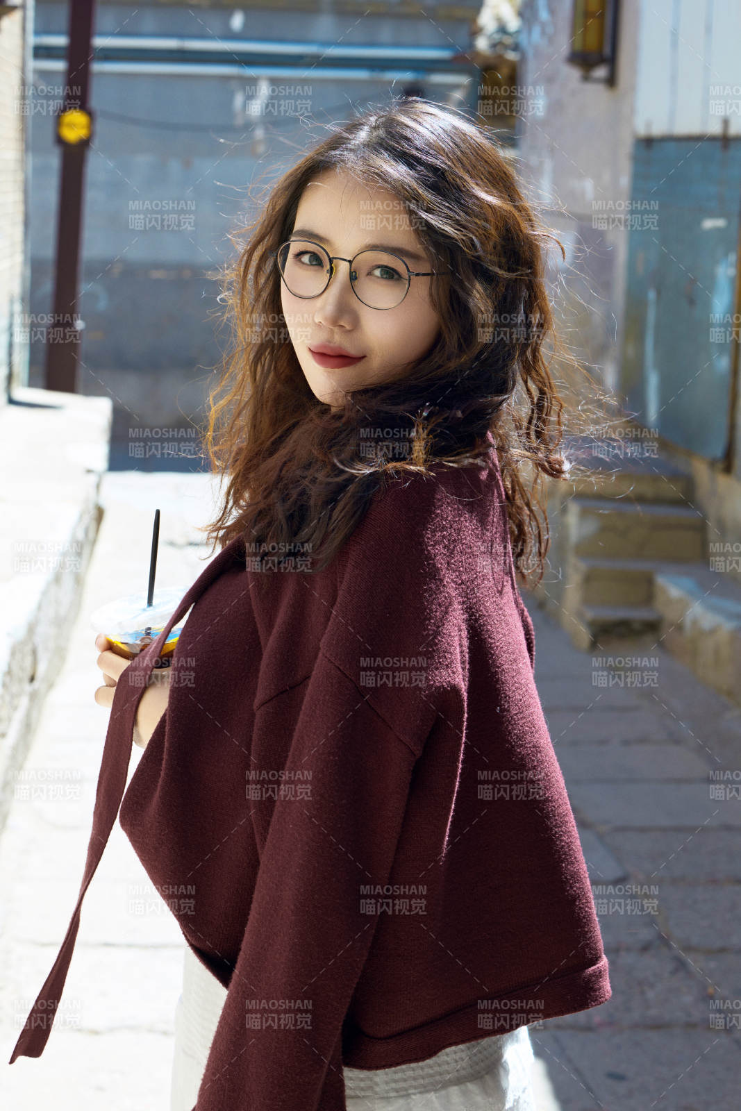 在老旧城区拍照游玩的东方美女图片