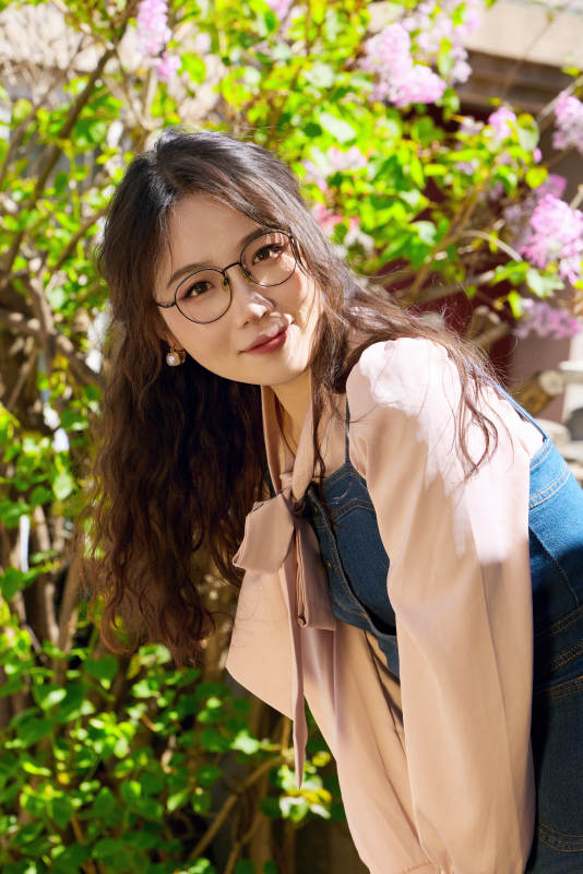 春天在梨花树下拍照的东方美女图片