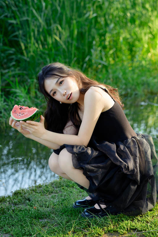 夏天在户外公园吃西瓜的亚州美女图片