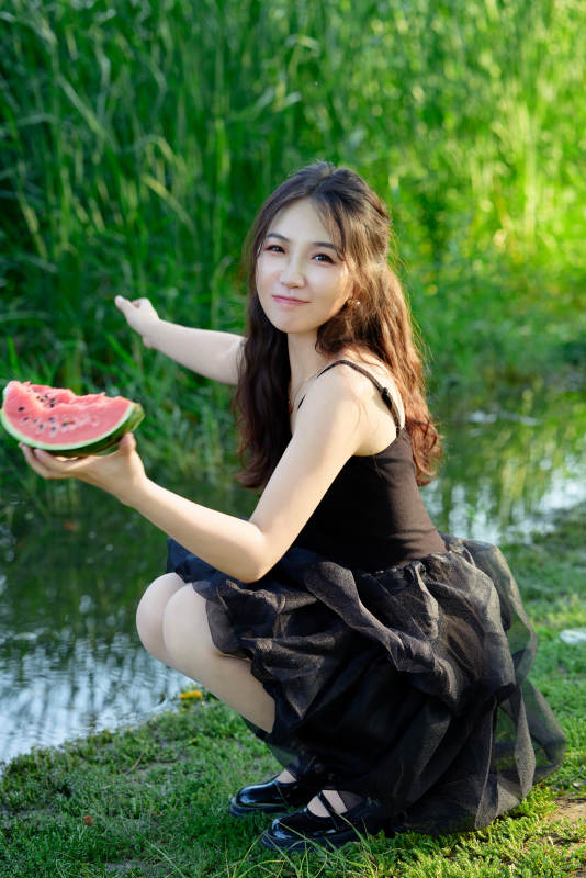 夏天在户外公园吃西瓜的亚州美女图片