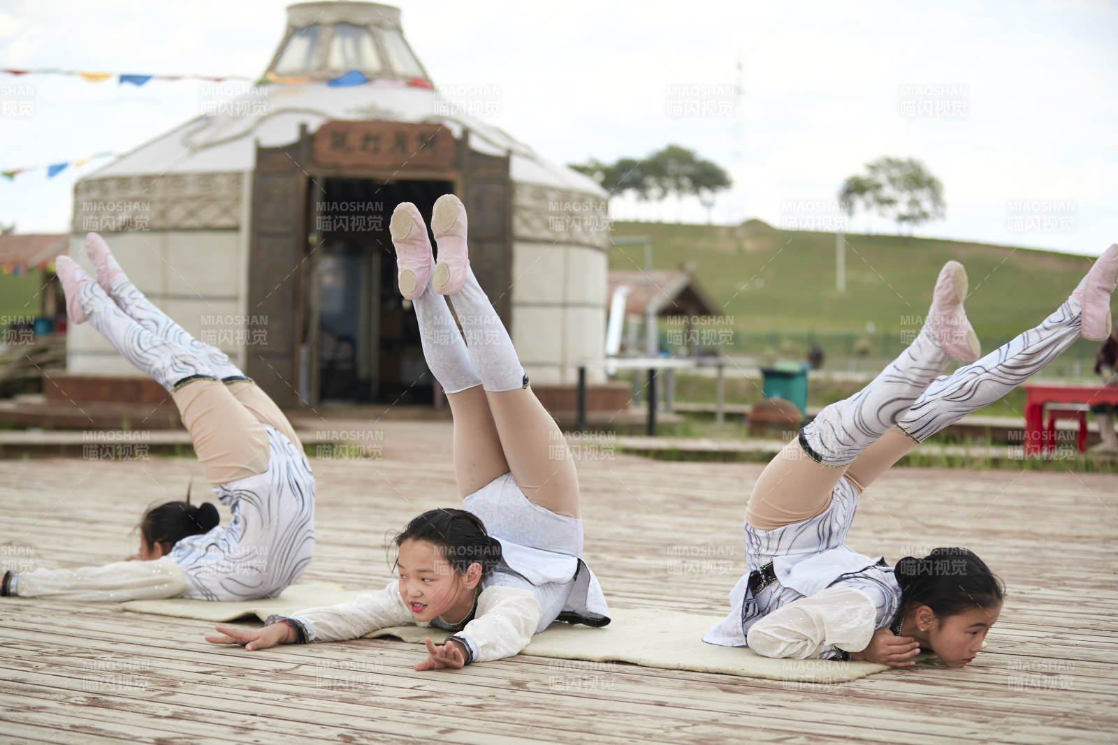 进行柔术体操杂技表演的三个少女图片