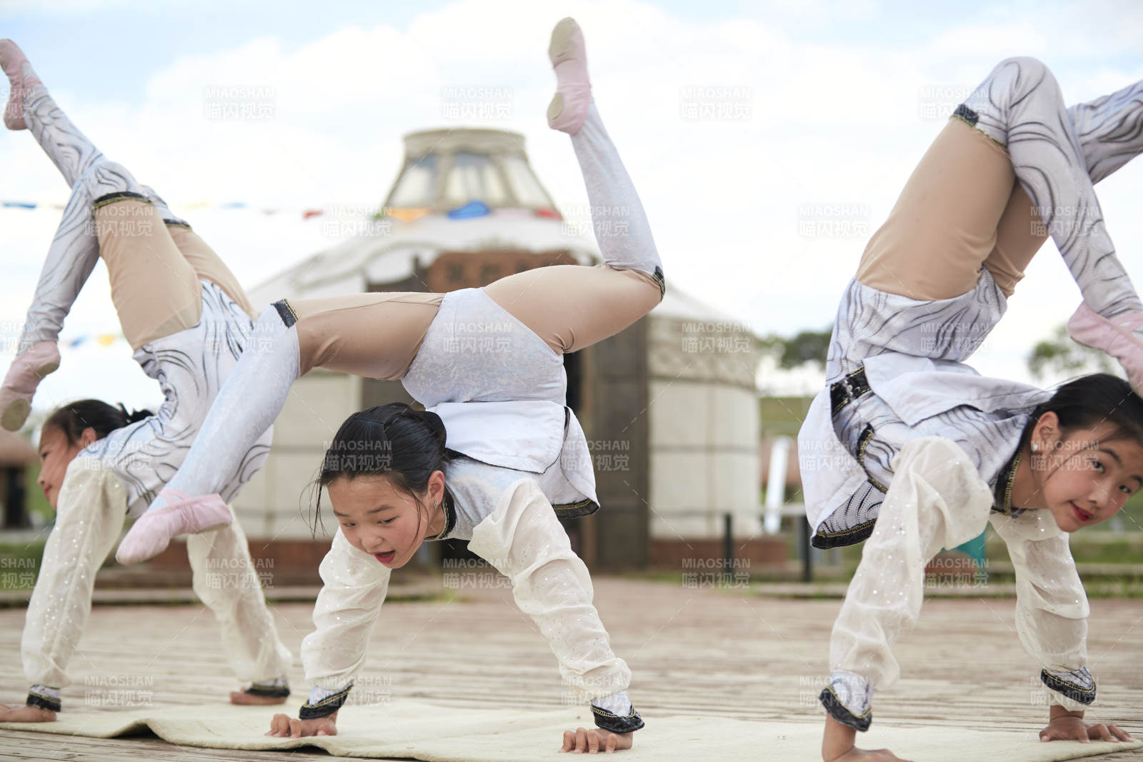 进行柔术体操杂技表演的三个少女图片