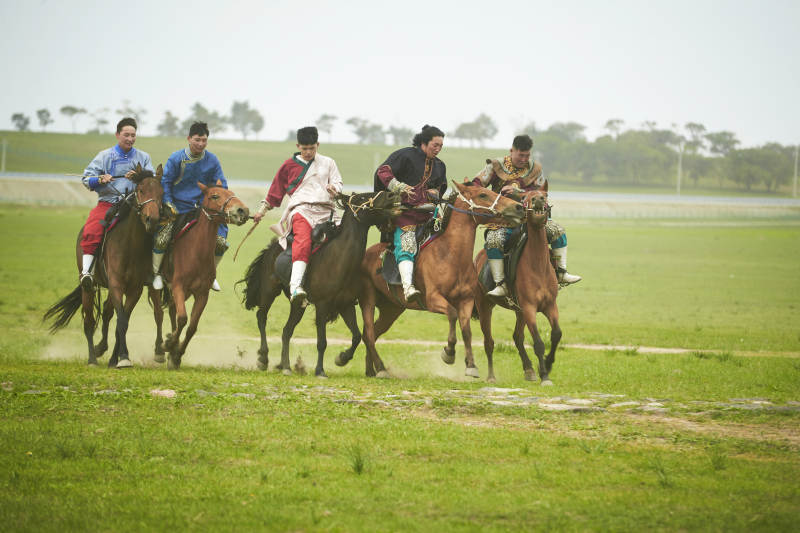 草原那达慕大会上骑着马的蒙古演员图片