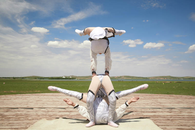 进行柔术体操杂技表演的三个少女图片