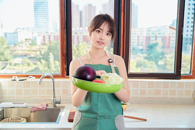 在厨房下厨做饭的年轻亚洲女性图片