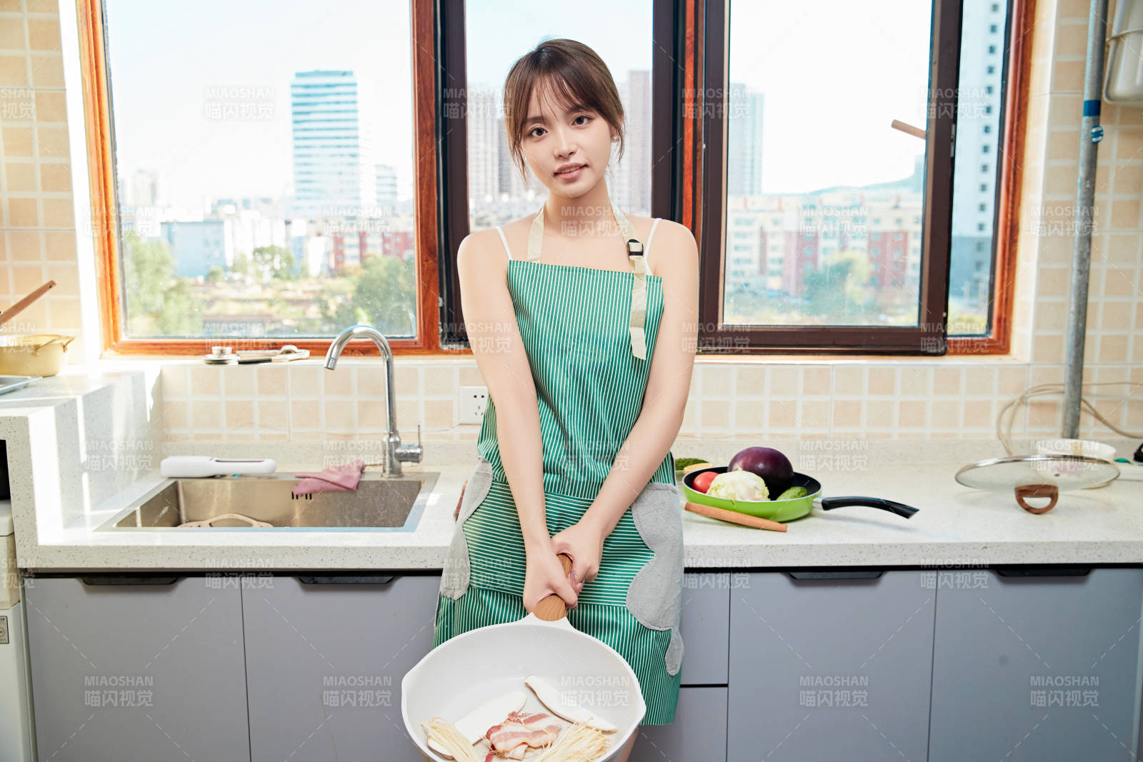 在厨房下厨做饭的年轻亚洲女性图片