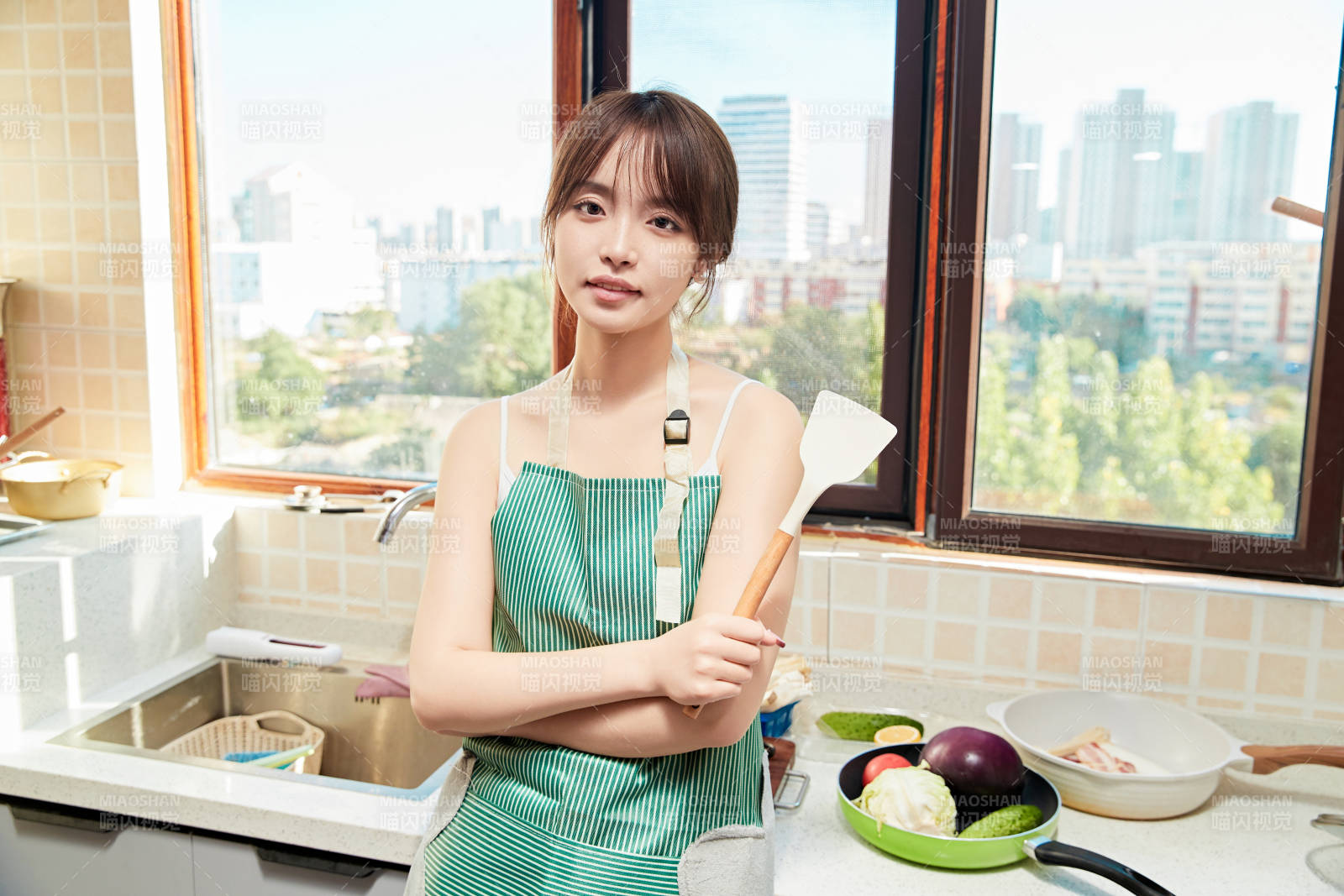 在厨房下厨做饭的年轻亚洲女性图片