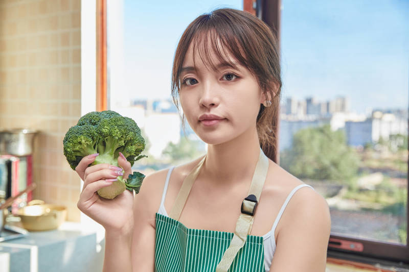 在厨房下厨做饭的年轻亚洲女性图片