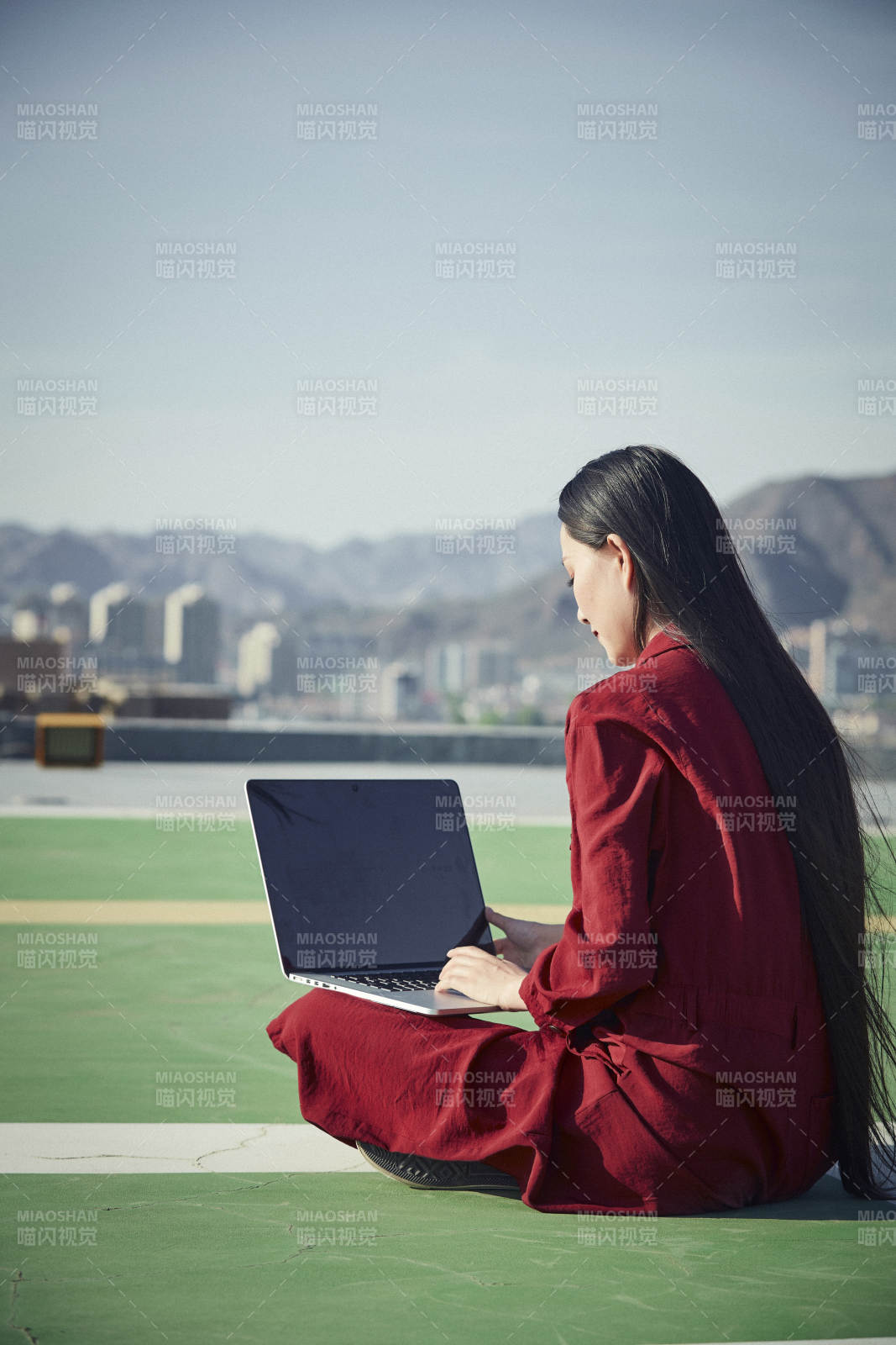 亚洲商务年轻女性在楼顶停机坪使用电脑办公图片
