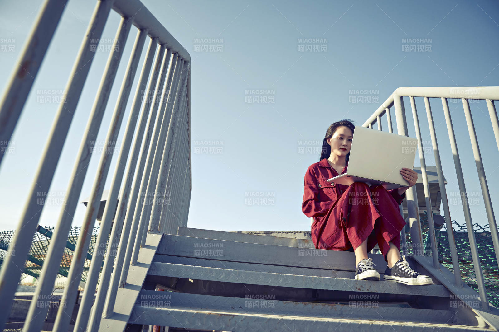 亚洲商务年轻女性在楼顶停机坪使用电脑办公图片