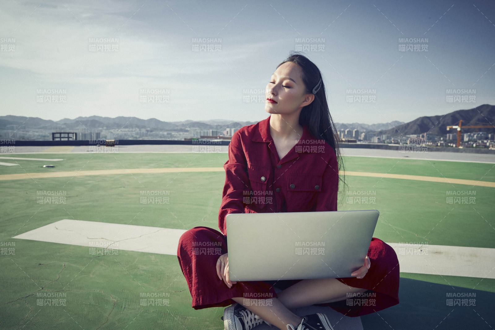 亚洲商务年轻女性在楼顶停机坪使用电脑办公图片