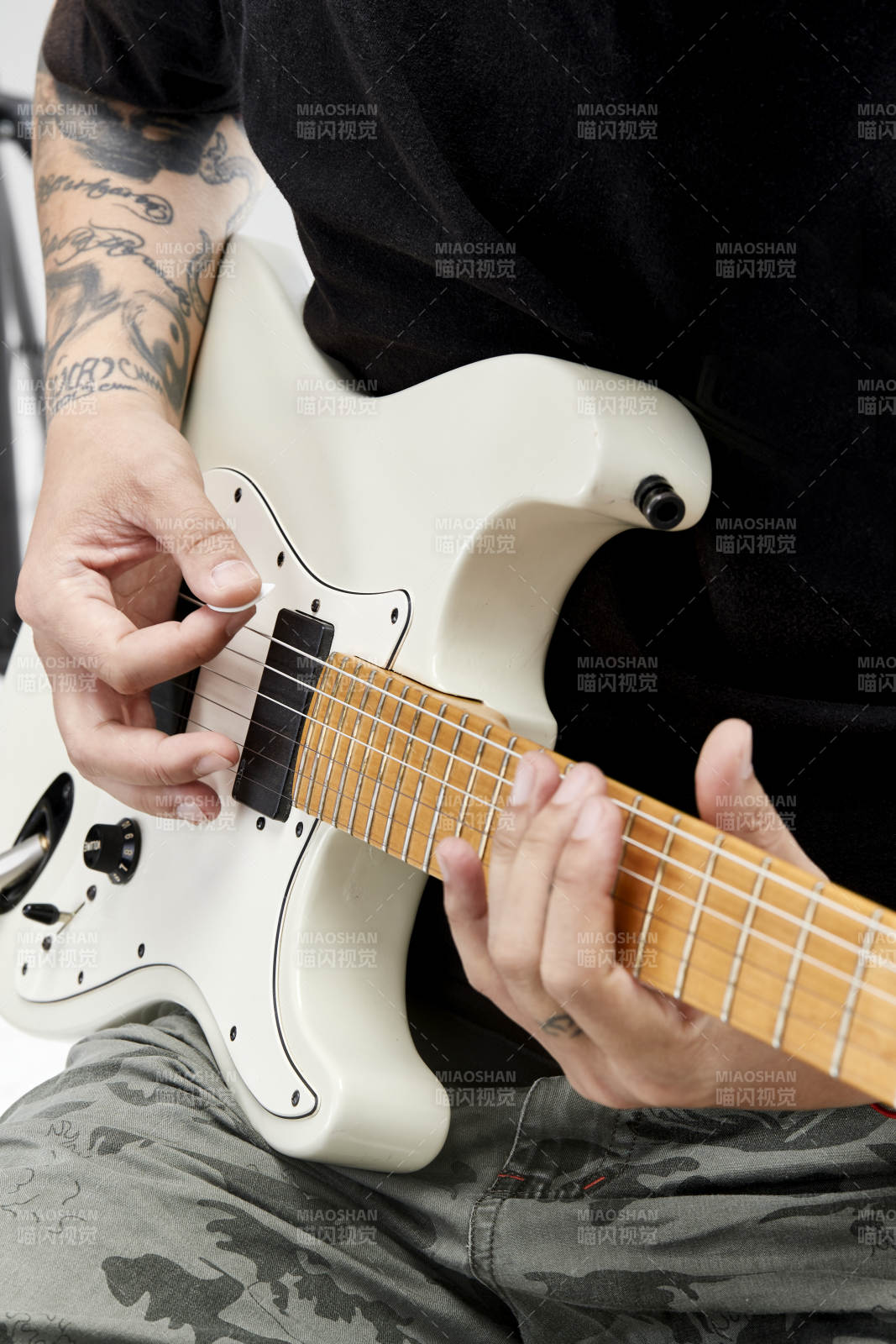 示范演奏摇滚电吉他的亚洲男性乐手人像局部特写图片