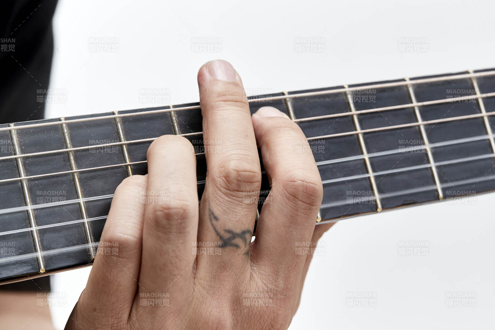 示范演奏古典吉他的亚洲男性乐手人像局部特写图片