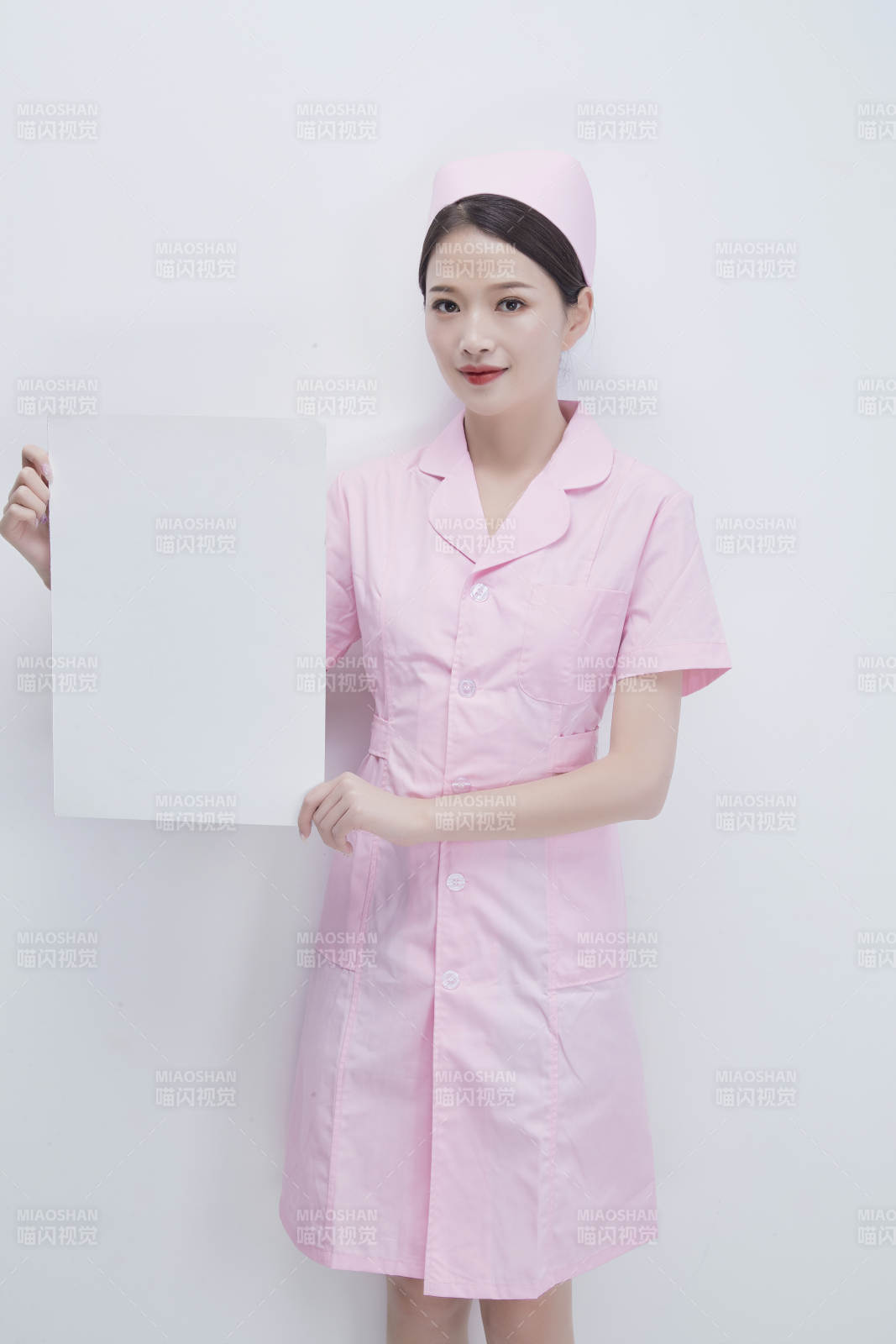 身穿粉色护士服佩戴听诊器的女性医护人员图片