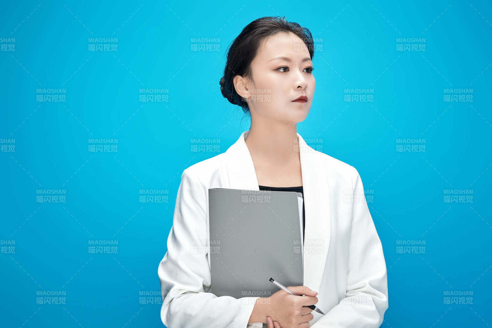 身穿西服拿着手机与文件夹的亚洲商务女士图片