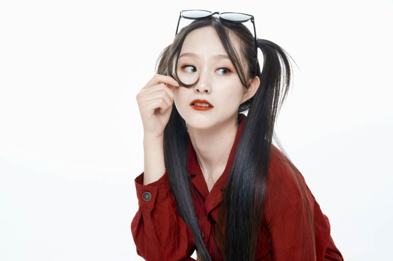 白色背景的亚洲戴墨镜年轻少女的肖像人像图片