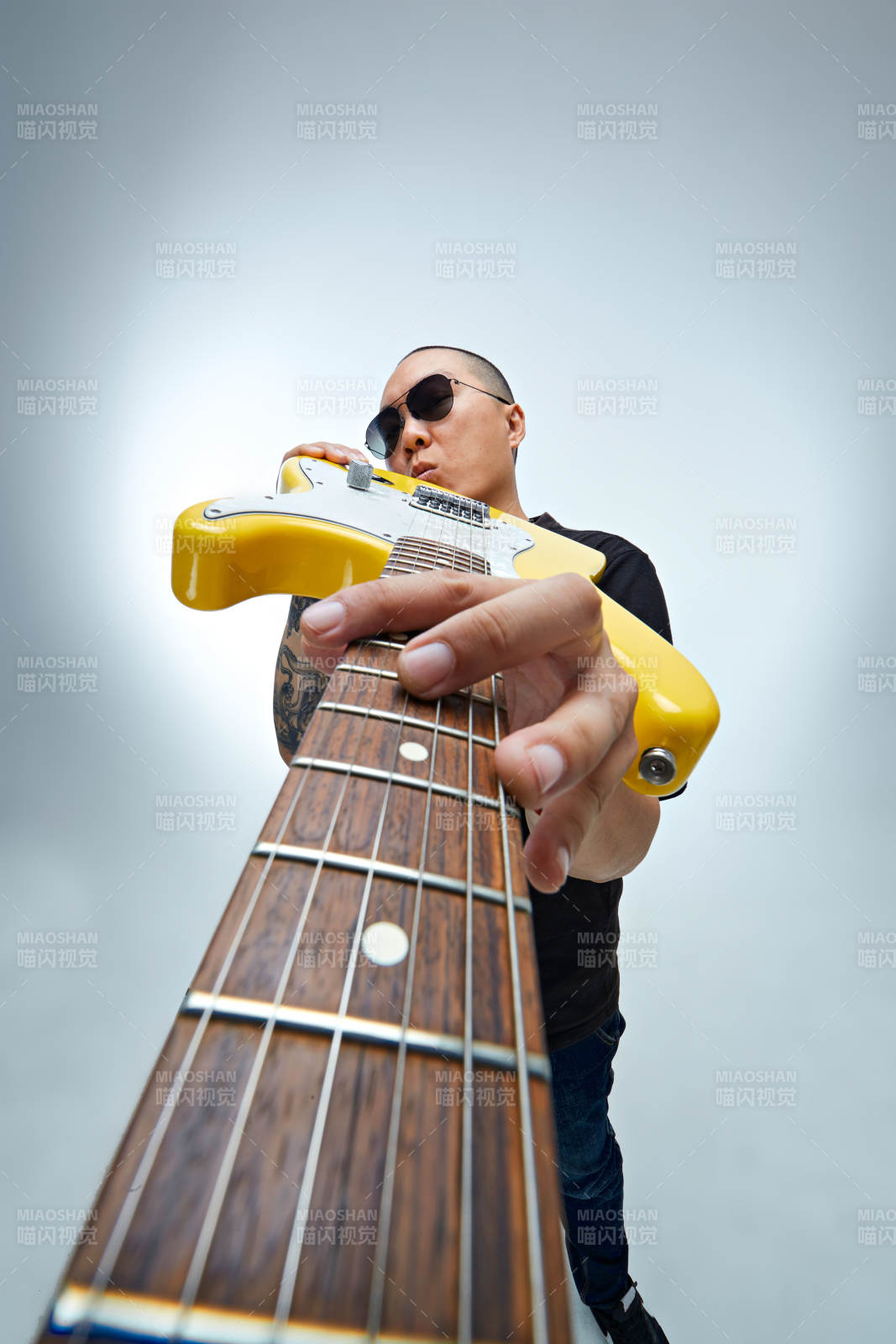 手持电吉他展示演奏的亚洲男性摇滚乐手人像图片