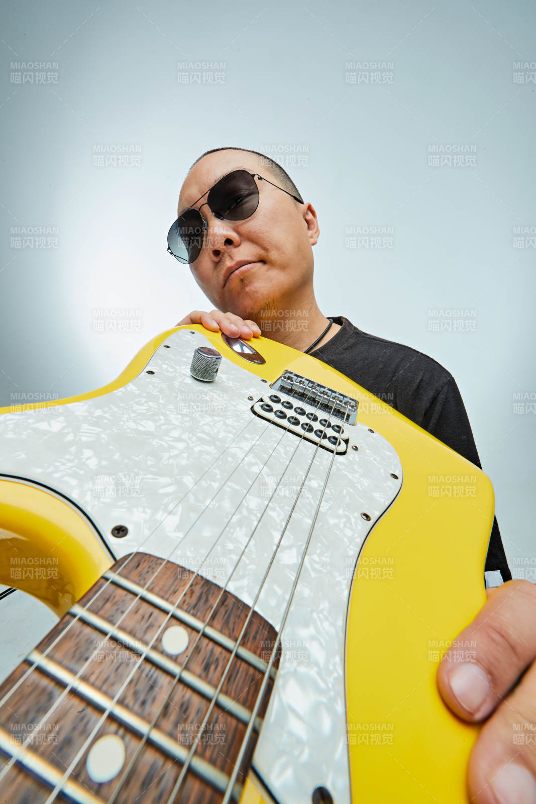 手持电吉他展示演奏的亚洲男性摇滚乐手人像图片