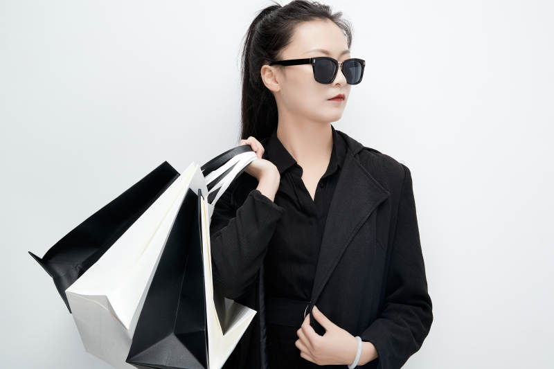 白色背景下手提购物袋时尚美丽的亚洲少女图片