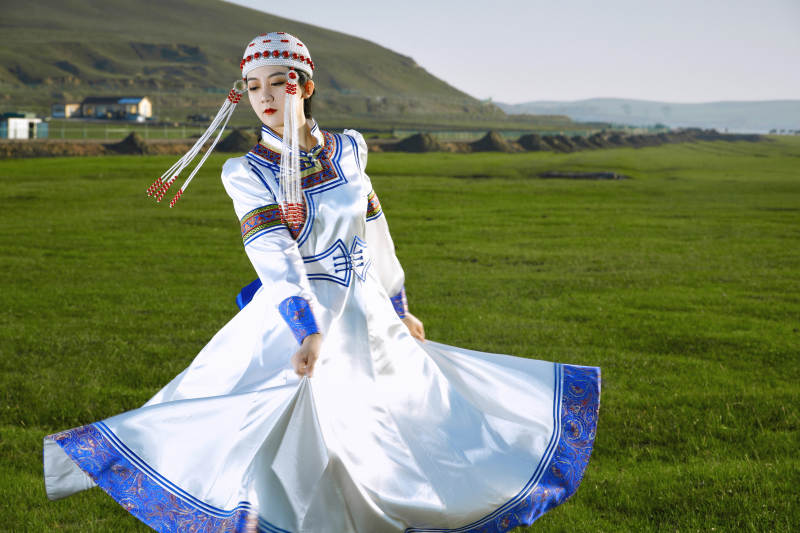 草原上穿着蒙古族传统服饰的亚洲年轻美少女图片