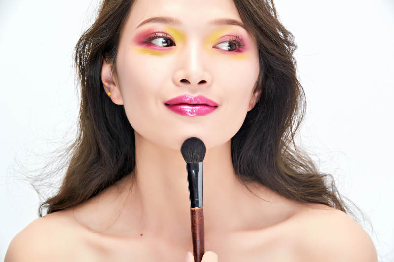 白色背景下棚拍化妆中的美女图片