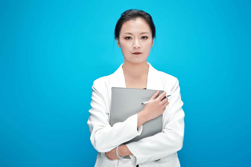 身穿西服拿着手机与文件夹的亚洲商务女士图片