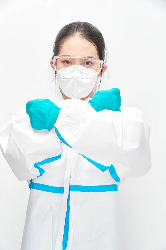 穿白色防护服佩戴护目镜口罩的女性医疗人员图片