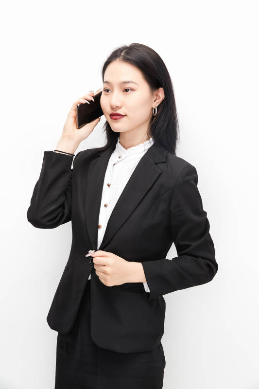 身穿西服拿着手机的美丽商务女士图片