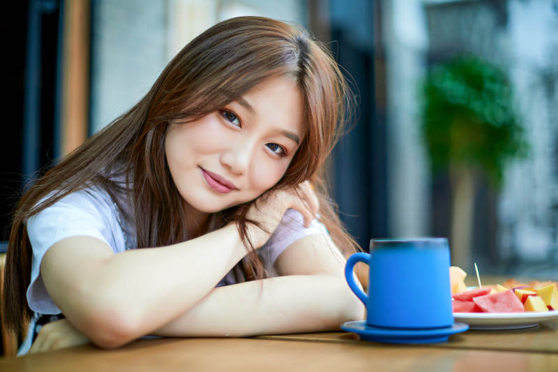 坐在咖啡图书馆吃东西的可爱少女图片