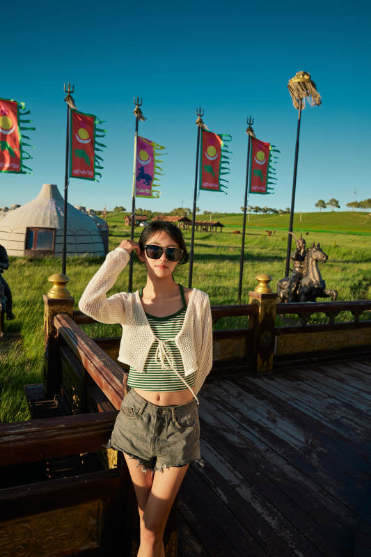 草原湿地公园游玩拍照的亚洲少女图片