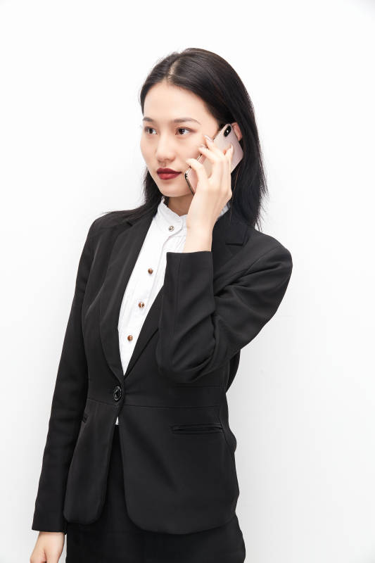 身穿西服拿着手机的美丽商务女士图片