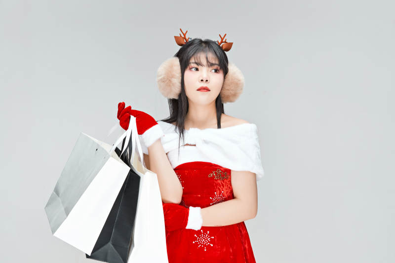 身穿圣诞服饰手提购物袋性感可爱的圣诞女郎图片