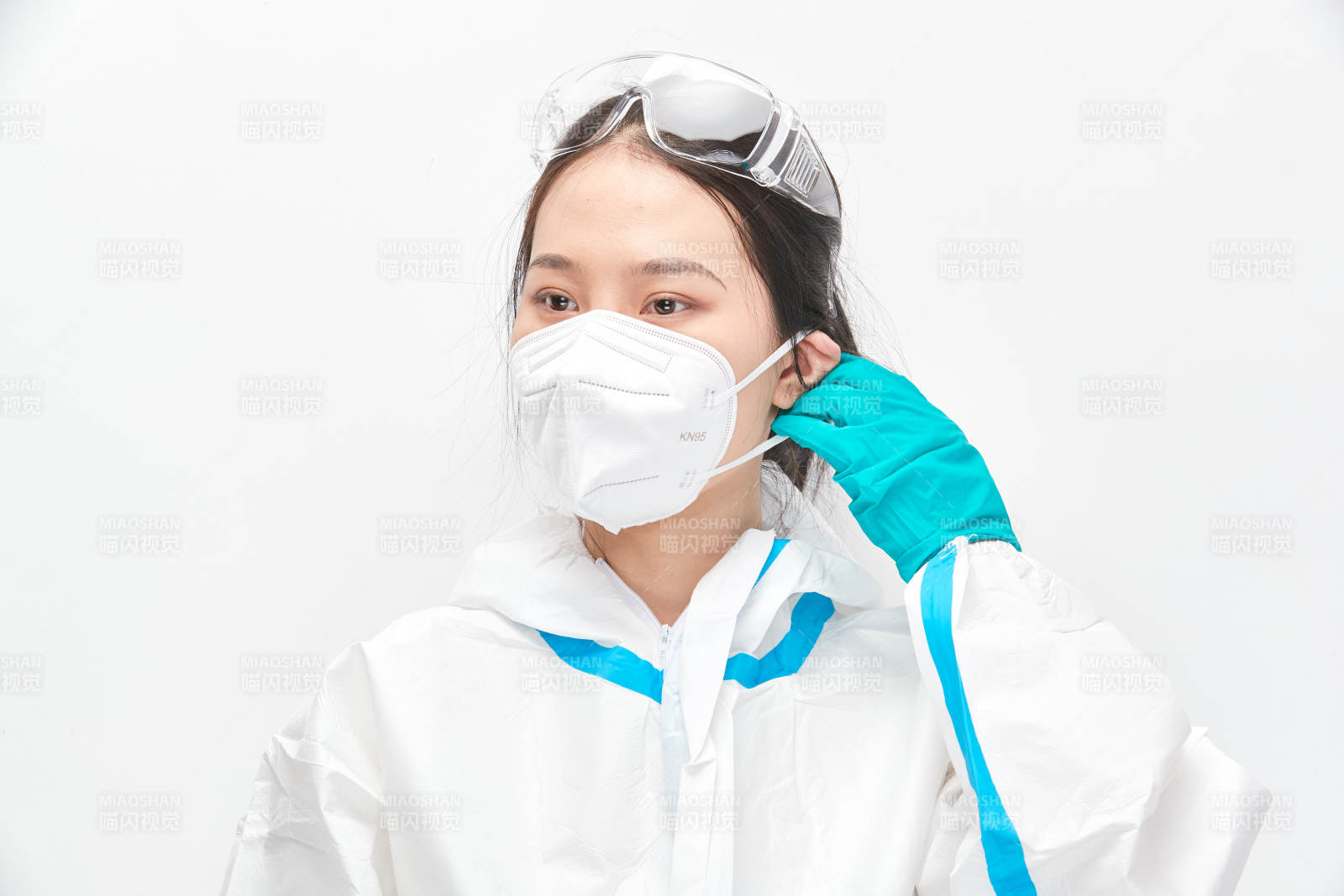 穿白色防护服佩戴护目镜口罩的女性医疗人员图片