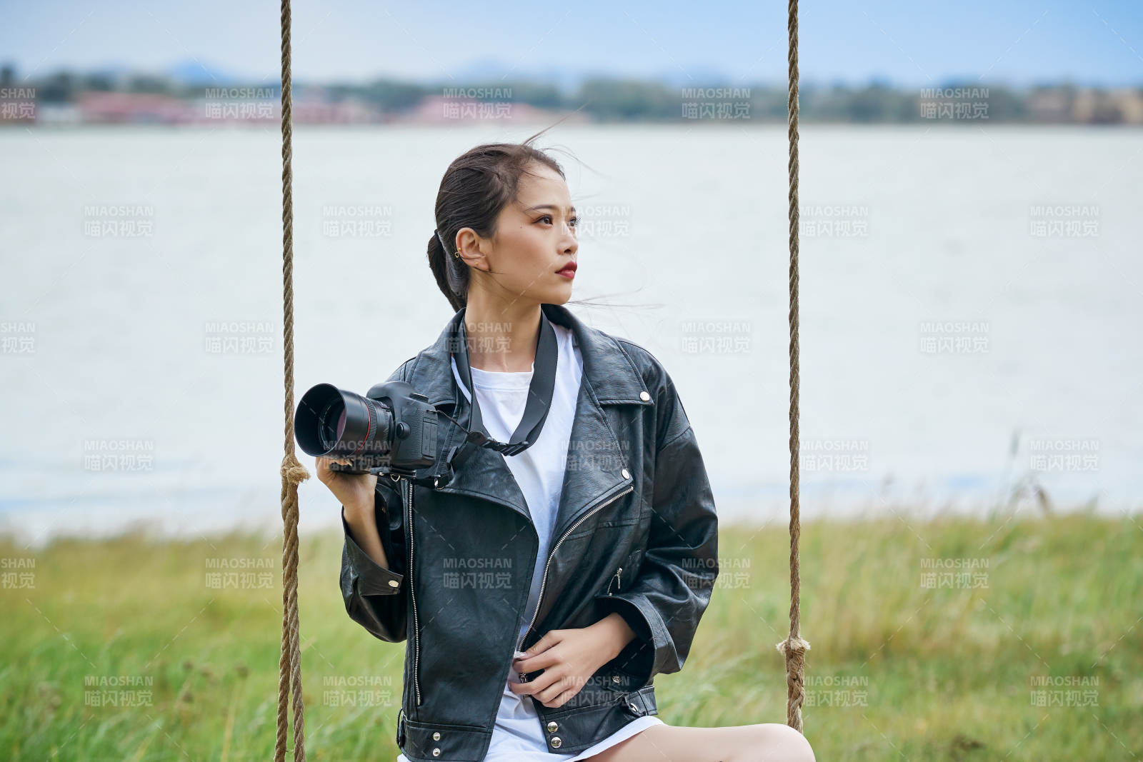 户外湖畔进行拍摄的亚洲青年女性摄影师图片