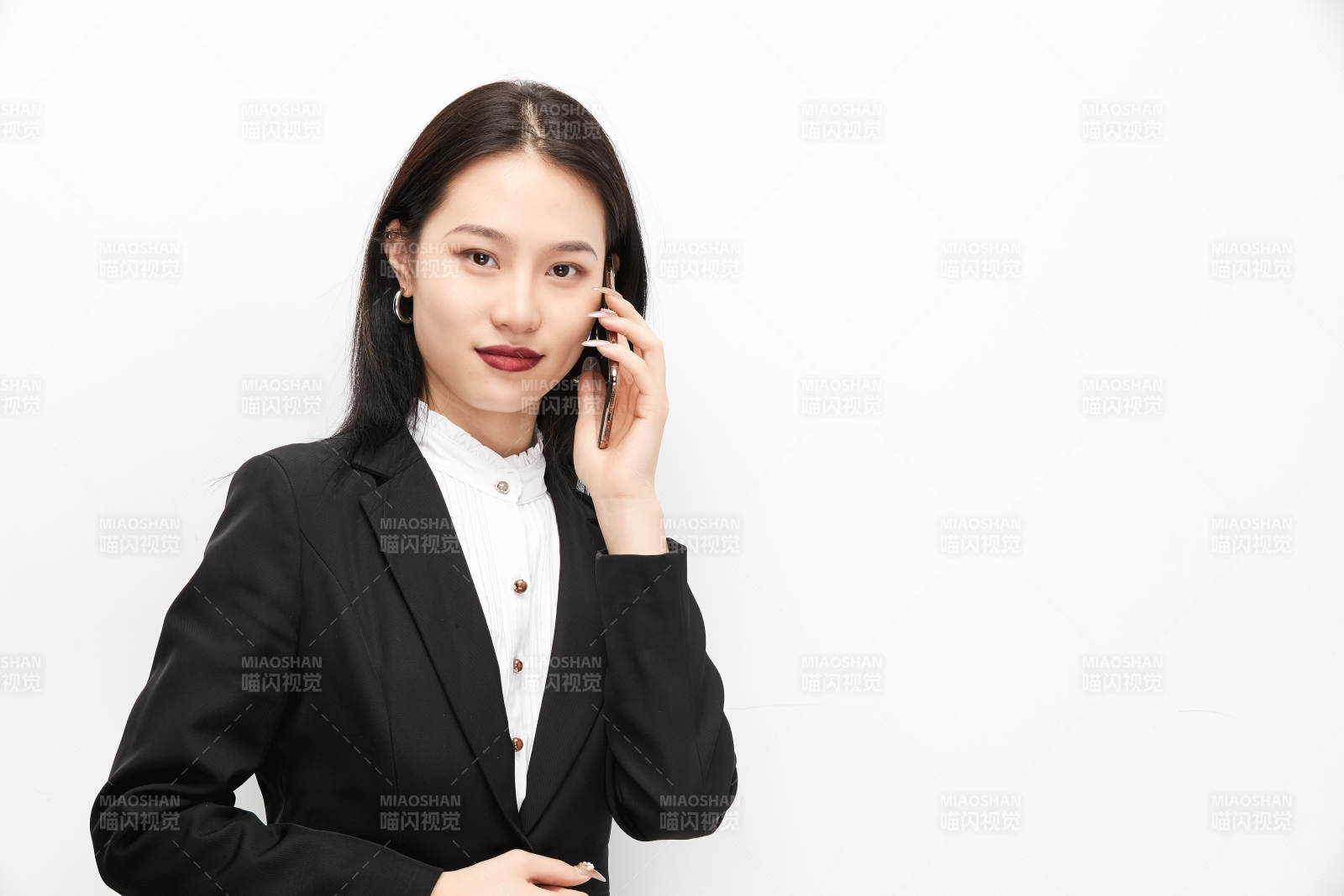 身穿西服拿着手机的美丽商务女士图片