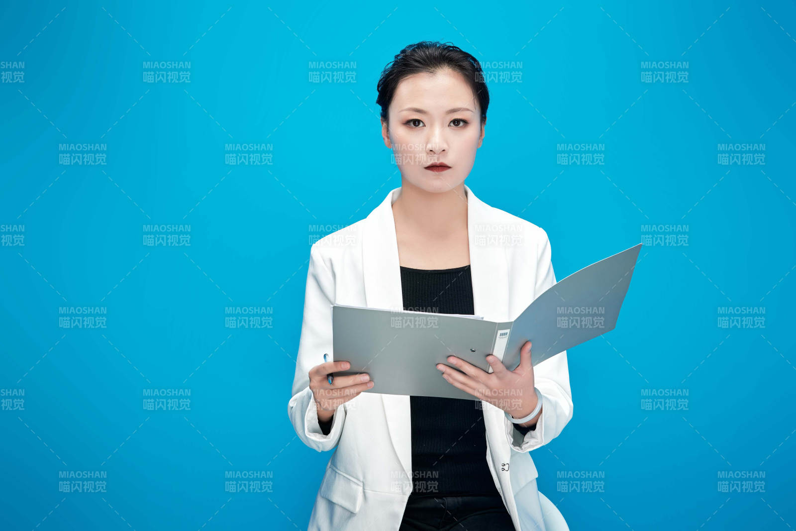 身穿西服拿着手机与文件夹的亚洲商务女士图片