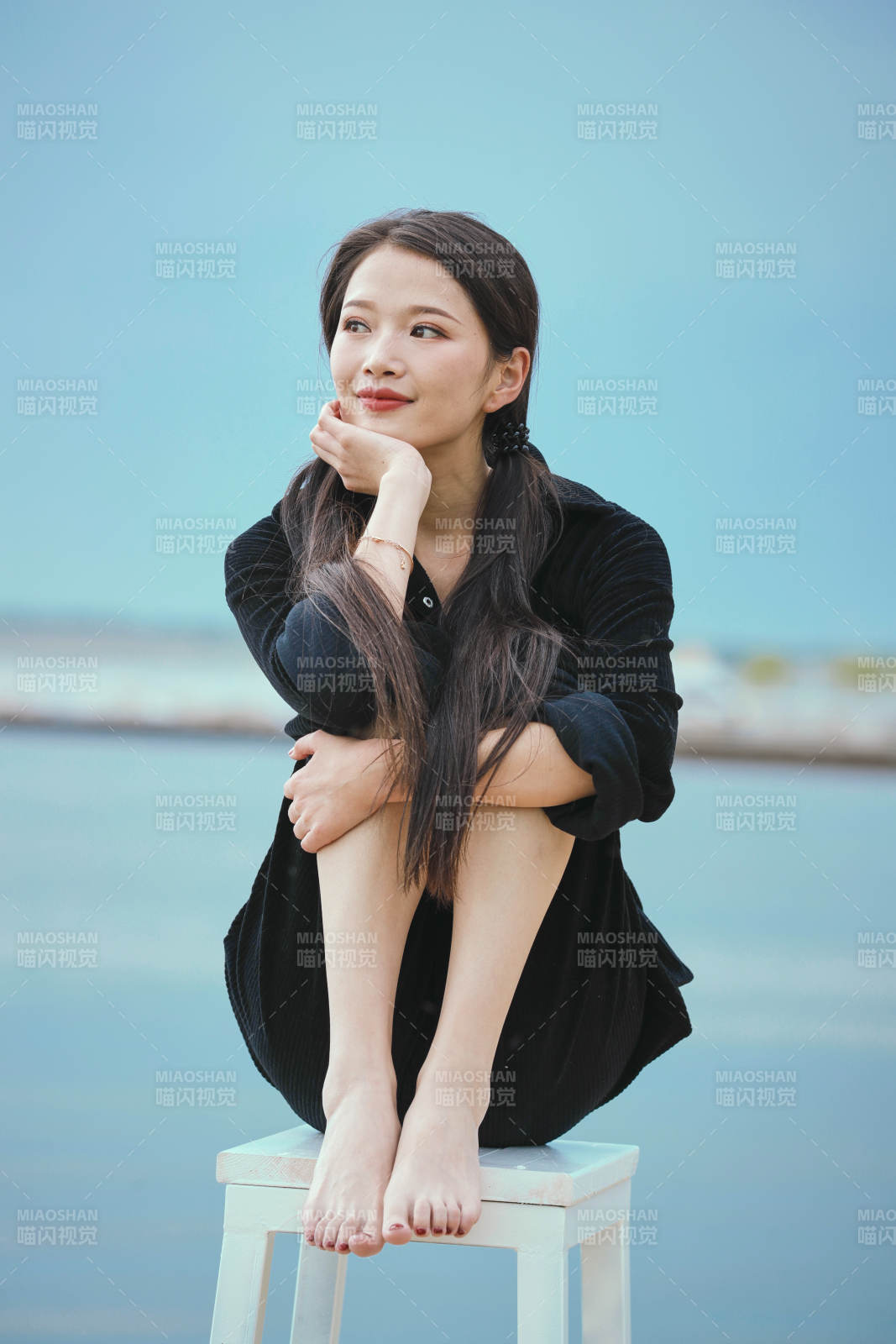 悠闲的坐在美丽湖岸码头的亚洲年轻女性人像图片