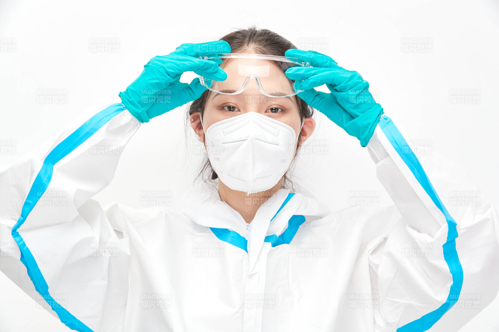 穿白色防护服佩戴护目镜口罩的女性医疗人员图片