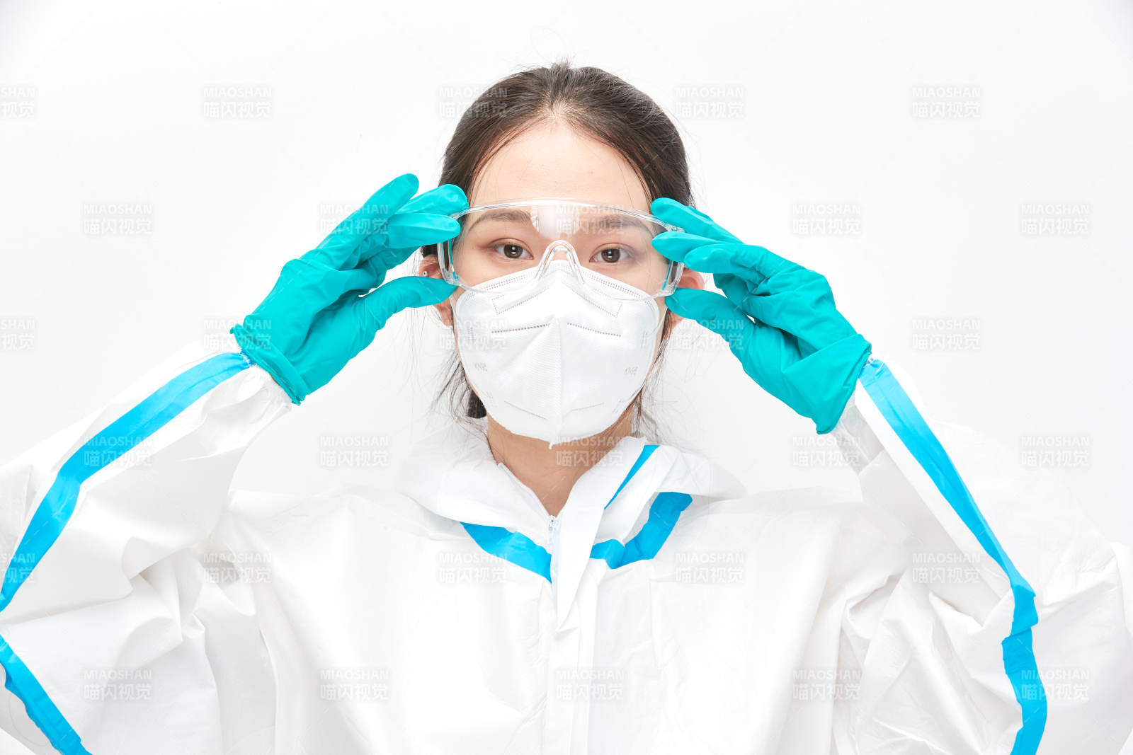 穿白色防护服佩戴护目镜口罩的女性医疗人员图片