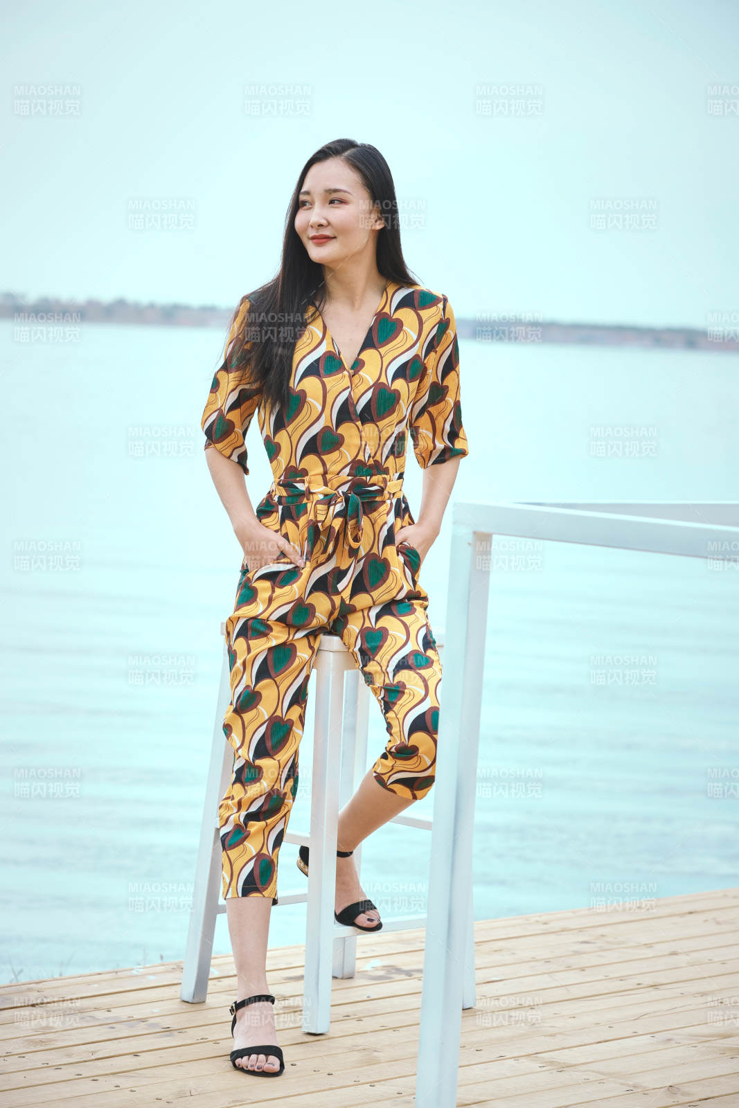 悠闲的坐在美丽湖岸码头的亚洲年轻女性人像图片