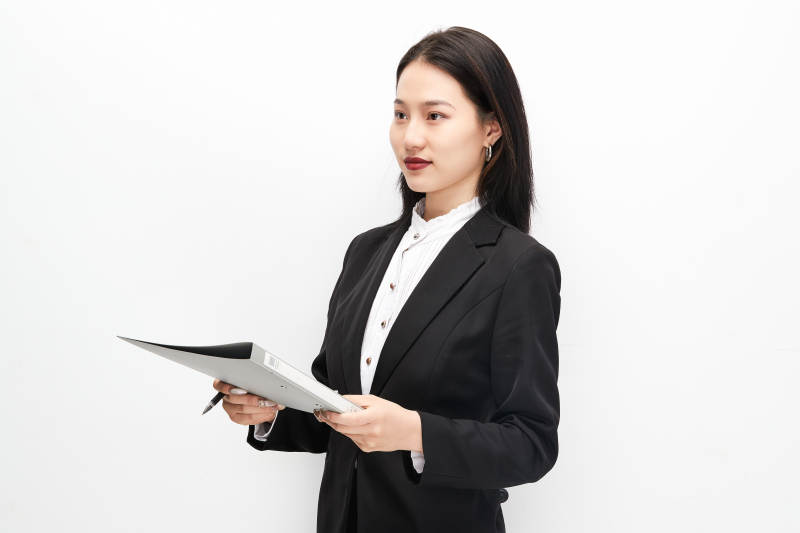 身穿西服拿着文件夹的美丽商务女士图片