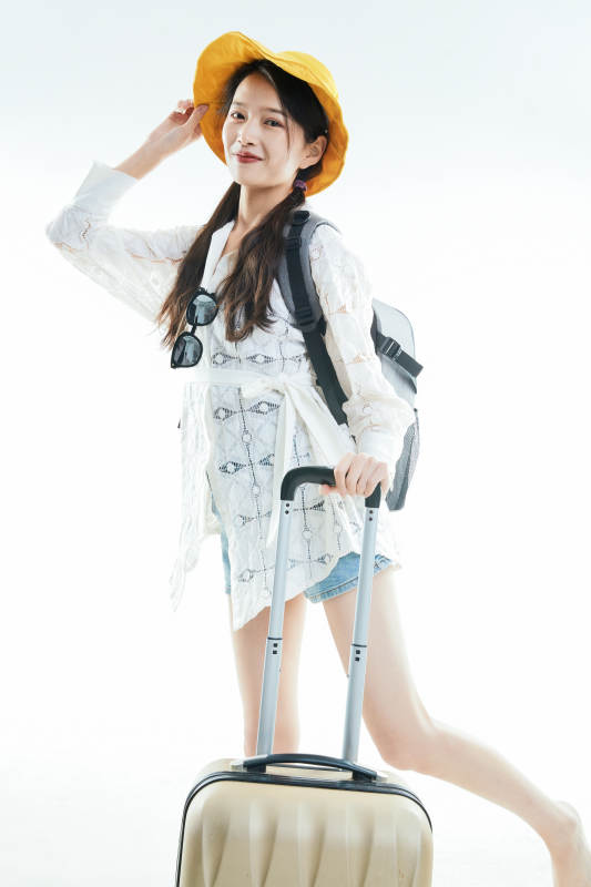 白色背景下准备出发旅行的美丽东方女大学生图片